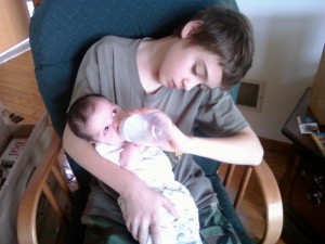 P feeds J his first bottle P feeds J