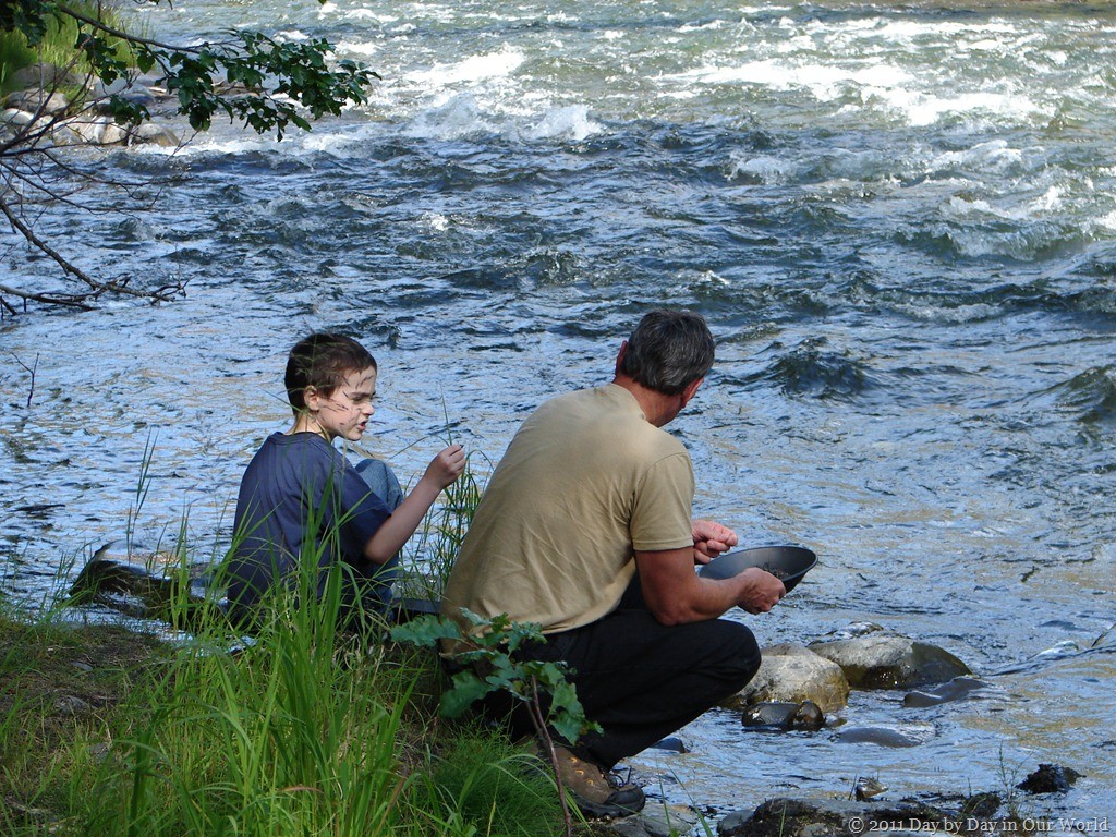 Boy and his uncle evaluate finds when gold panning