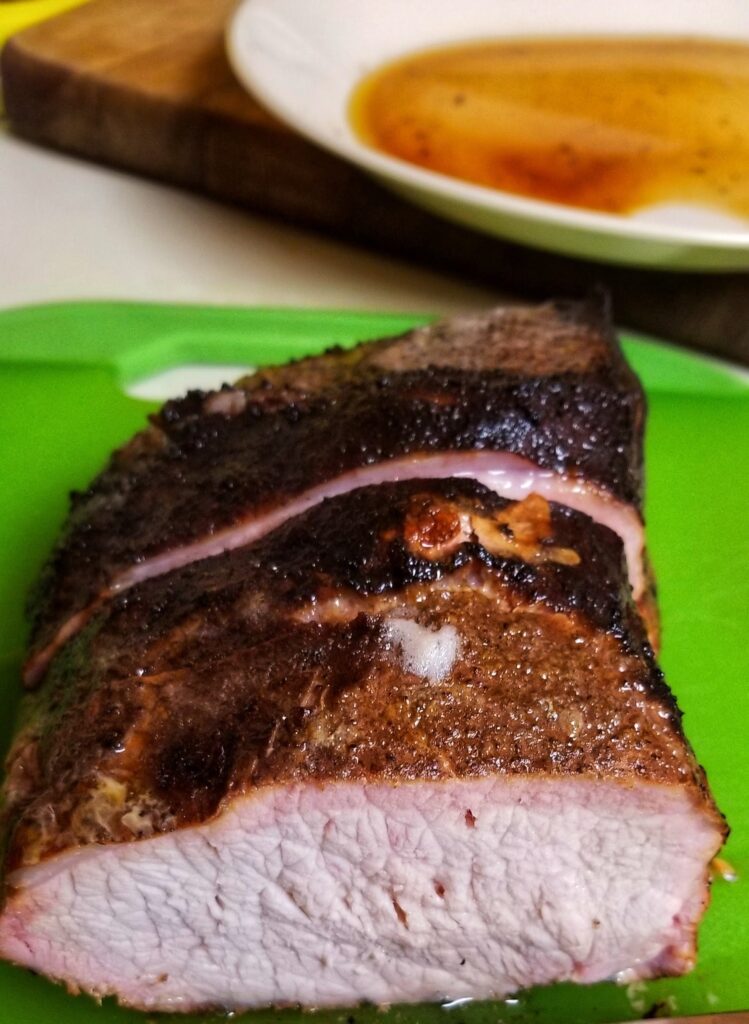 Pork Loin Roast, sliced to show ring of pink from the smoking.