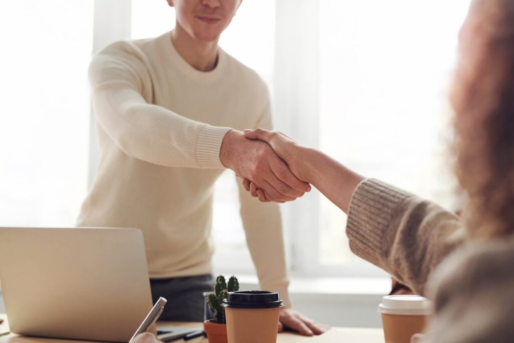 Man Shakes Woman's Hand
